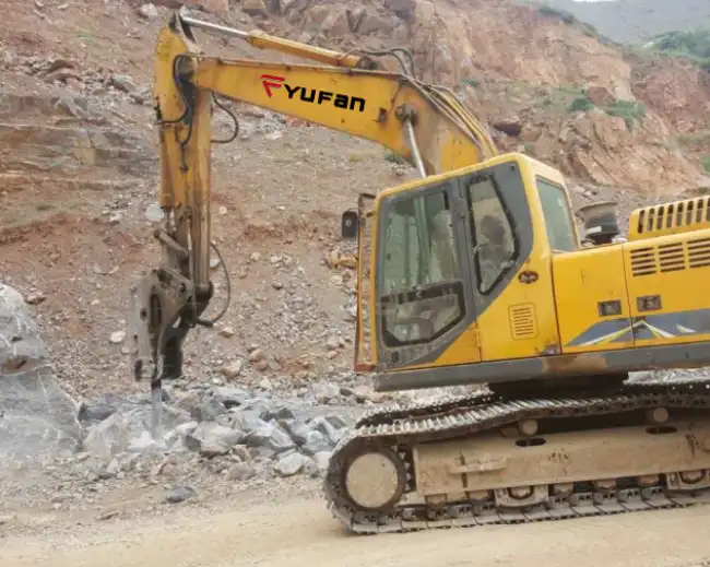 backhoe loader rock breaker working with quarry